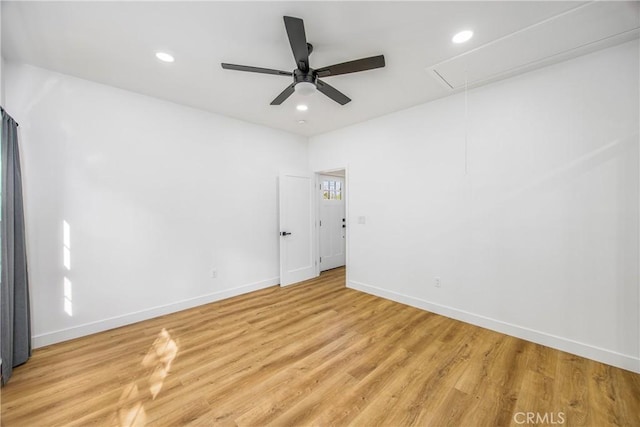 spare room with ceiling fan and light wood-type flooring