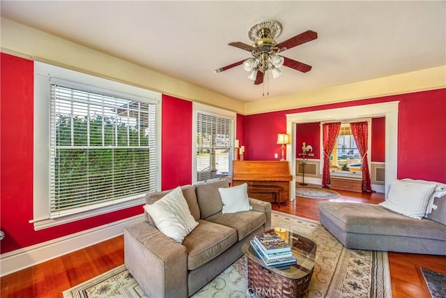 living room featuring ceiling fan and wood-type flooring