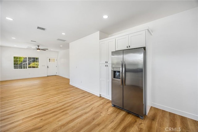 kitchen with white cabinetry, stainless steel fridge, ceiling fan, and light hardwood / wood-style flooring