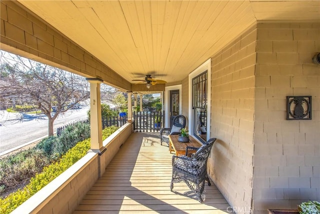 deck with ceiling fan and a porch