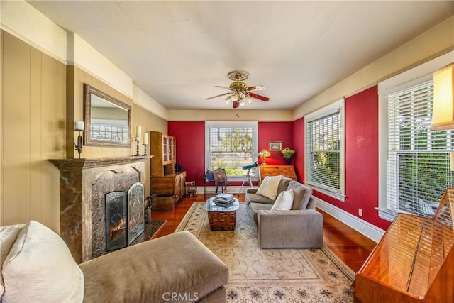 living room featuring hardwood / wood-style flooring, ceiling fan, and a wealth of natural light