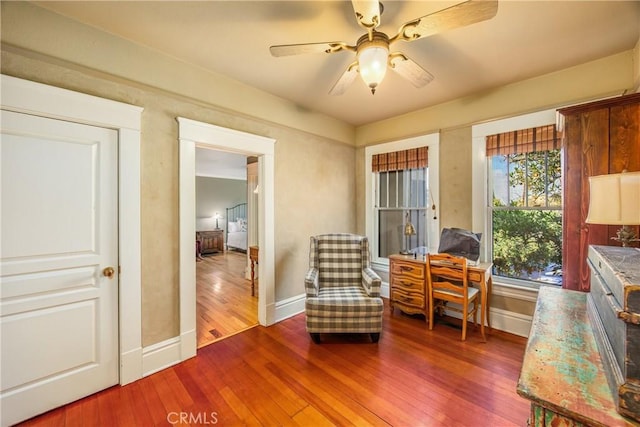 sitting room with hardwood / wood-style flooring and ceiling fan