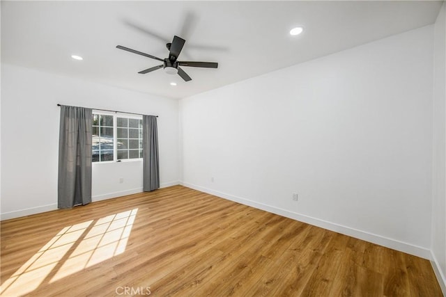 empty room with hardwood / wood-style flooring and ceiling fan