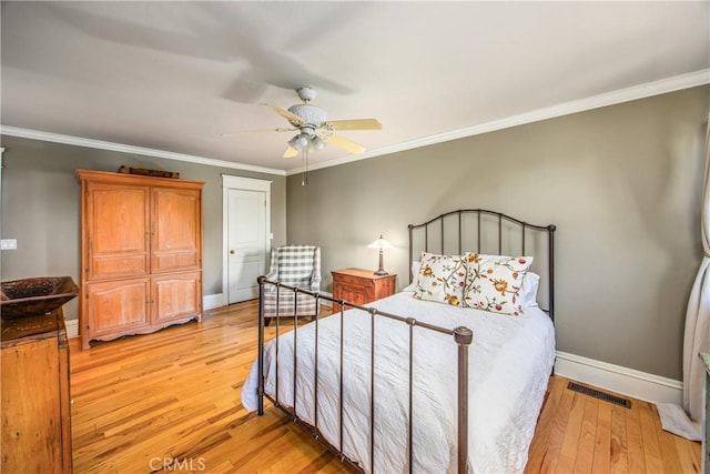 bedroom with crown molding, light hardwood / wood-style flooring, and ceiling fan