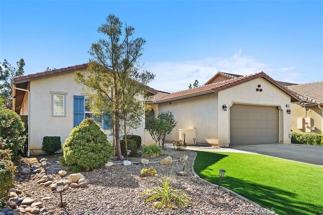 mediterranean / spanish-style home with a garage and a front yard