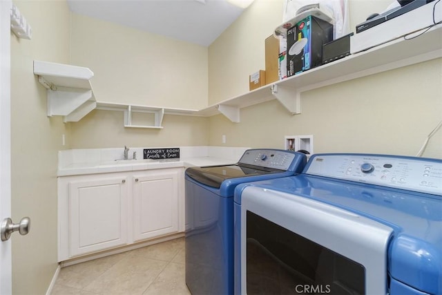 laundry room featuring light tile patterned floors, a sink, and washer and dryer