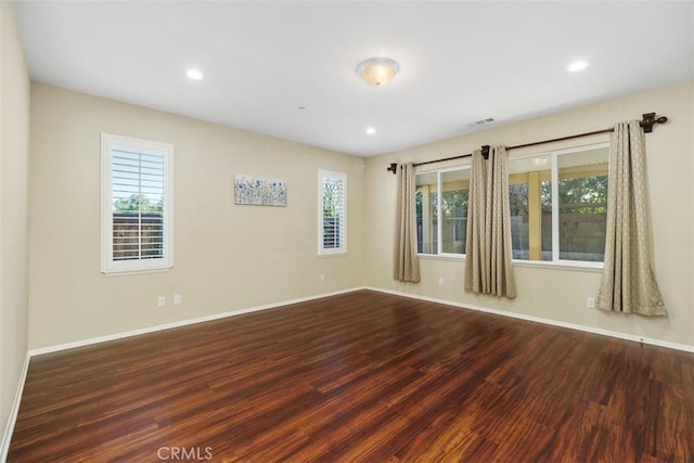 unfurnished room with recessed lighting, visible vents, baseboards, and wood finished floors