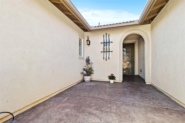 property entrance with a patio