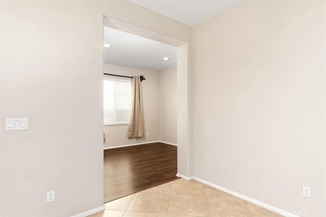 spare room featuring tile patterned flooring and baseboards