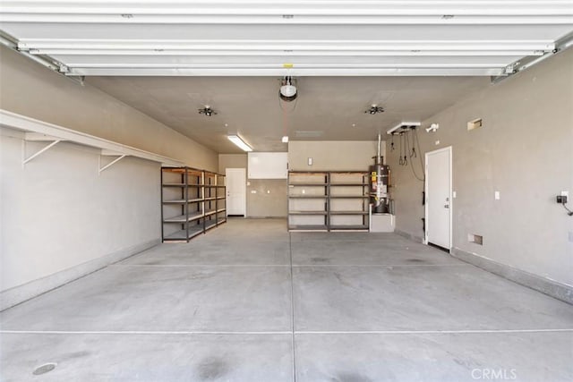 garage featuring water heater and baseboards