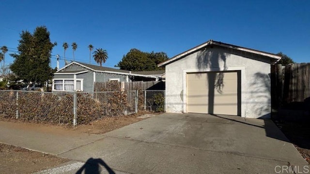 view of front facade featuring a garage and an outbuilding