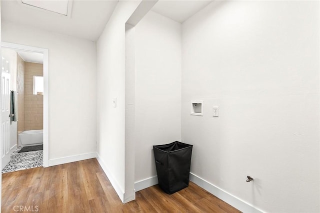 clothes washing area with wood-type flooring and hookup for a washing machine