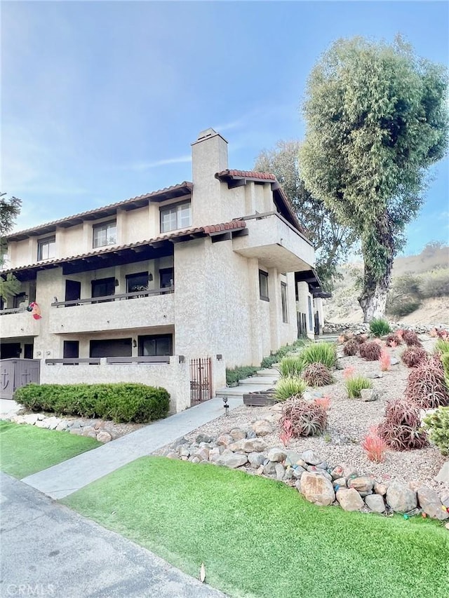1 Cabrillo Dr, Avalon, CA 90704 - view of side of home featuring a chimney and stucco siding