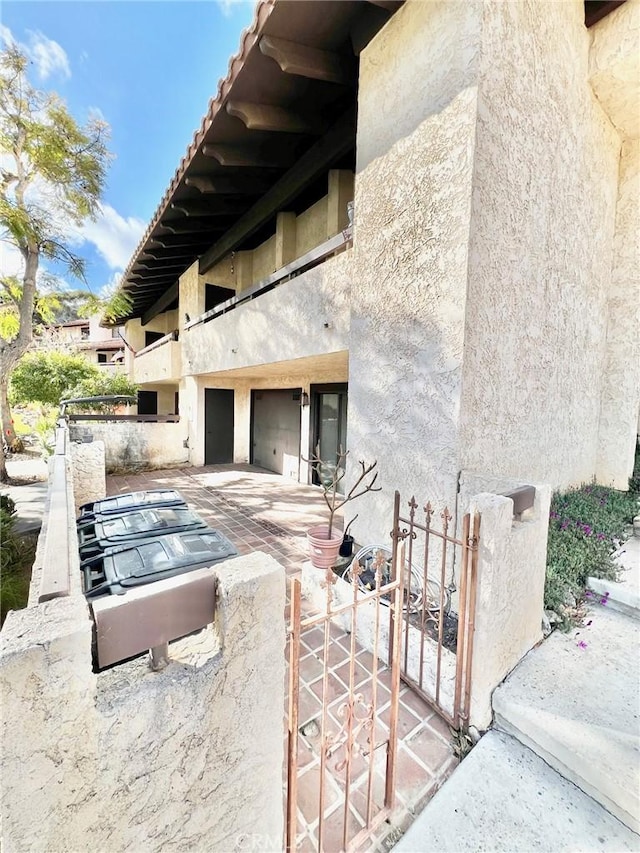 1 Cabrillo Dr, Avalon, CA 90704 - back of house featuring stucco siding and a garage