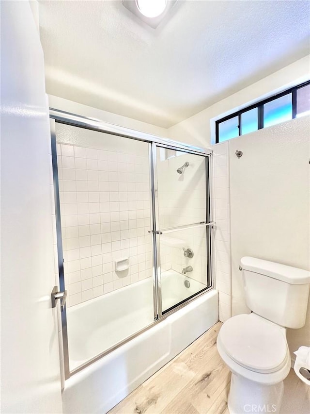 1 Cabrillo Dr, Avalon, CA 90704 - bathroom with wood finished floors, combined bath / shower with glass door, toilet, and a textured ceiling