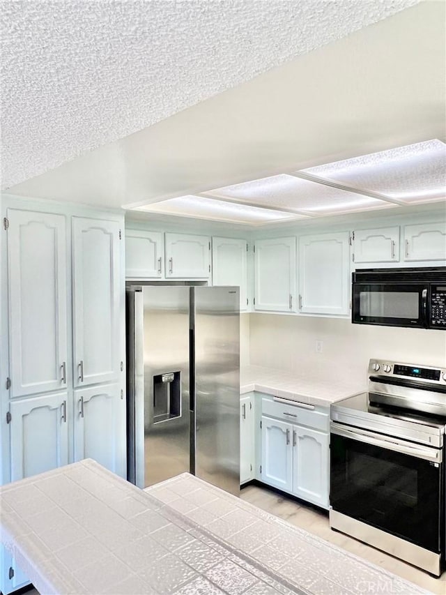 1 Cabrillo Dr, Avalon, CA 90704 - kitchen with appliances with stainless steel finishes, tile counters, and a textured ceiling