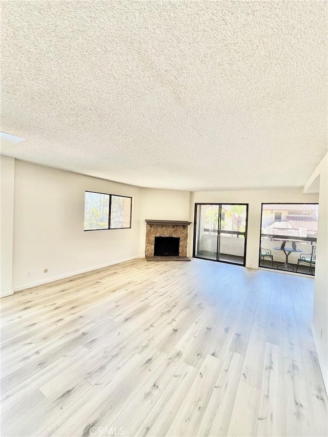 1 Cabrillo Dr, Avalon, CA 90704 - unfurnished living room with a textured ceiling, wood finished floors, and a fireplace