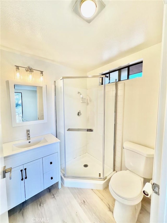 1 Cabrillo Dr, Avalon, CA 90704 - full bathroom featuring wood finished floors, toilet, vanity, and a shower stall