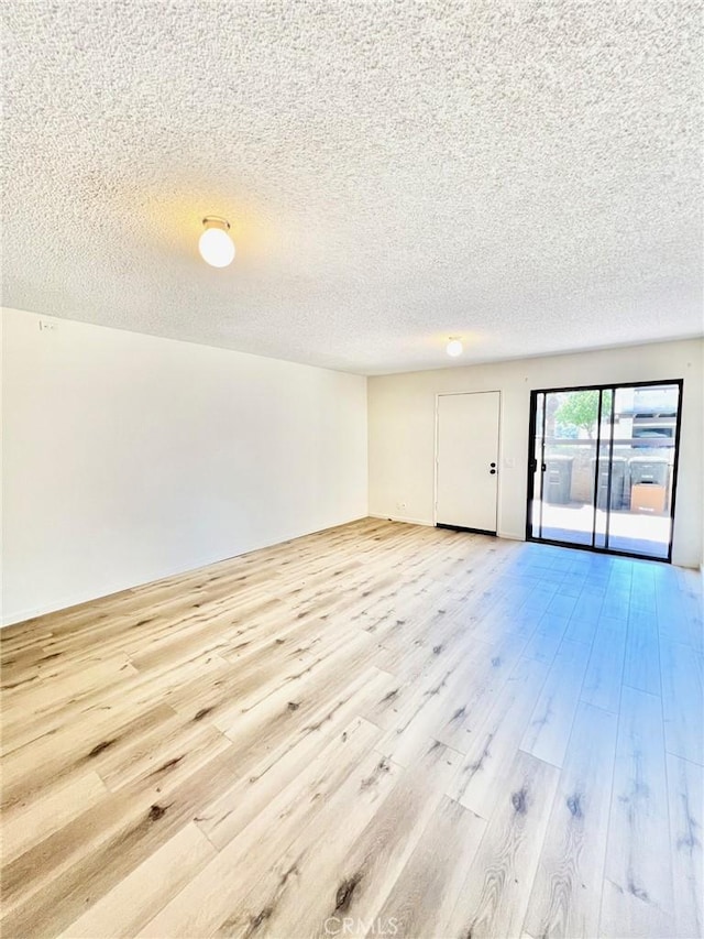 1 Cabrillo Dr, Avalon, CA 90704 - empty room featuring light wood-type flooring and a textured ceiling