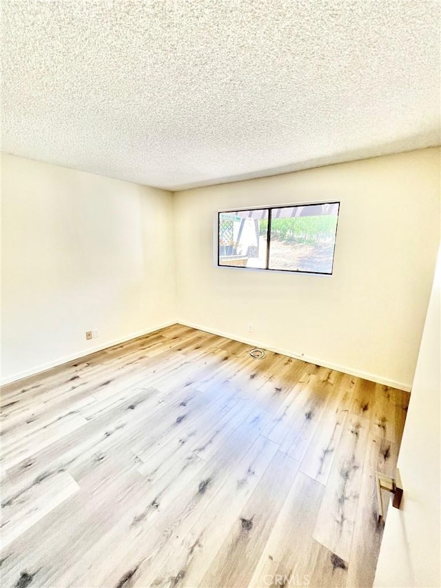 1 Cabrillo Dr, Avalon, CA 90704 - empty room featuring wood finished floors, a textured ceiling, and baseboards