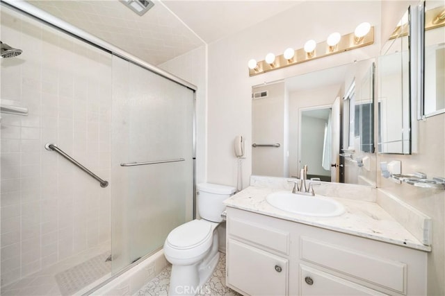 bathroom with a shower with shower door, tile patterned floors, toilet, and vanity