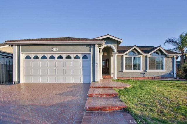 single story home with a garage and a front yard