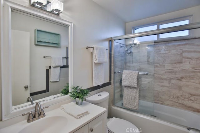 full bathroom with vanity, shower / bath combination with glass door, and toilet