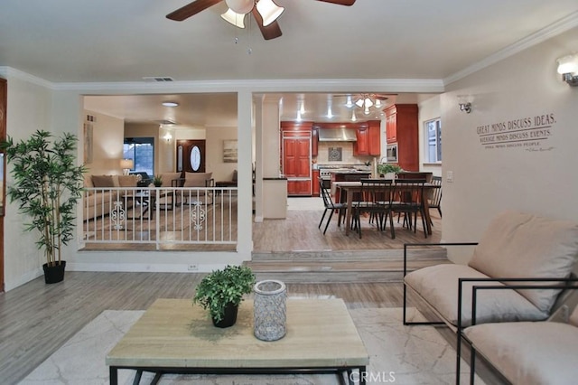 living room with ornamental molding, light hardwood / wood-style floors, and ceiling fan