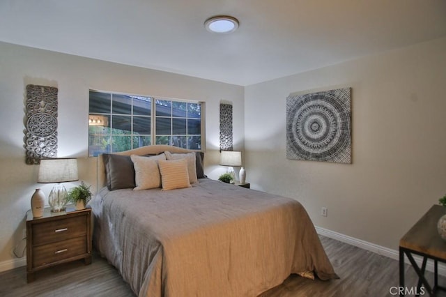 bedroom with dark hardwood / wood-style flooring