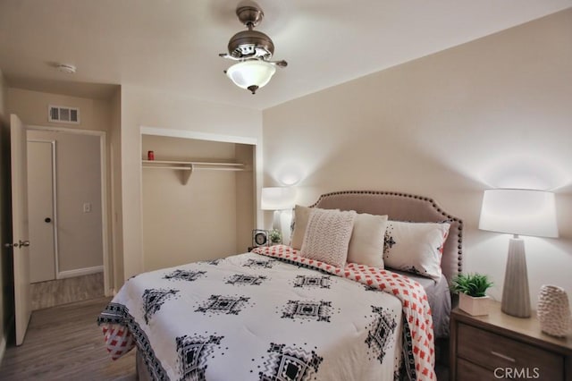 bedroom featuring wood-type flooring and a closet