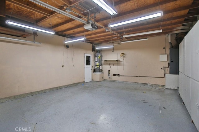 garage with a garage door opener, electric panel, and secured water heater