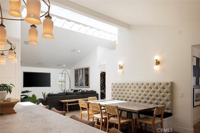 dining space with vaulted ceiling with beams