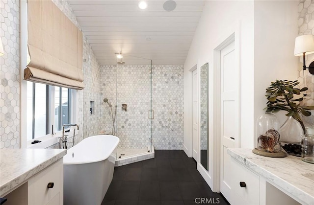 bathroom featuring vanity, lofted ceiling, and plus walk in shower