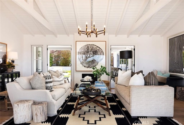 living room with an inviting chandelier, hardwood / wood-style flooring, and lofted ceiling with beams