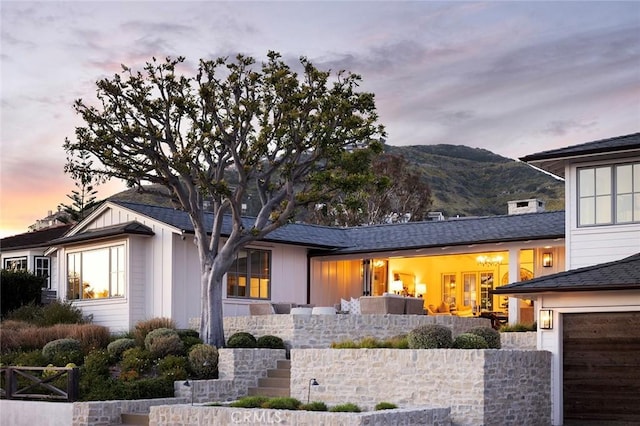 view of front of house featuring a garage and a mountain view