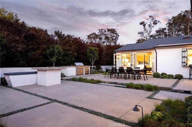 patio terrace at dusk with area for grilling