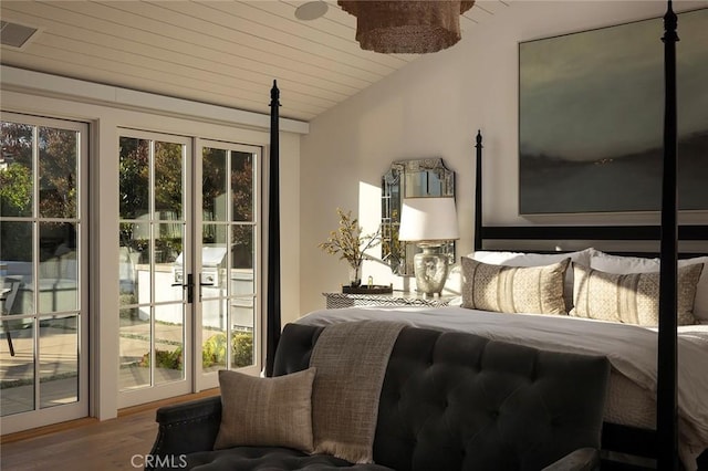 bedroom with wood ceiling, lofted ceiling, and hardwood / wood-style floors