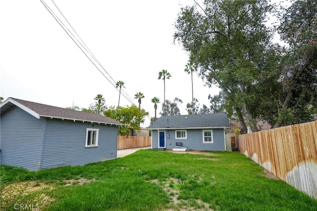 rear view of property with a lawn