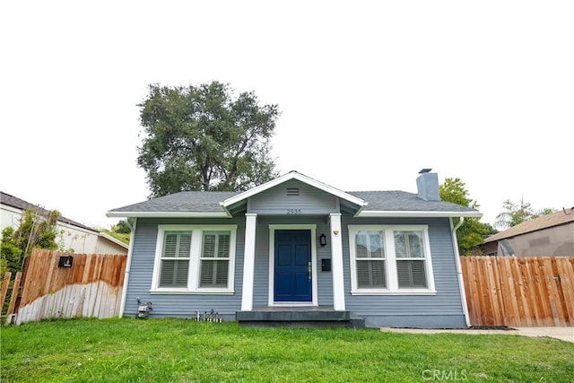 bungalow-style house with a front lawn