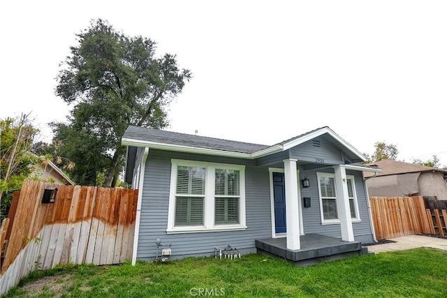 back of property featuring a lawn