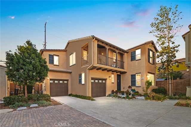 view of front of property with a garage and a balcony