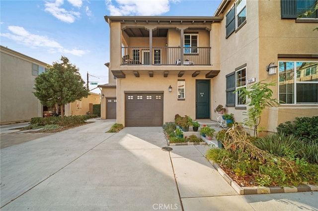 view of front of home with a garage and a balcony