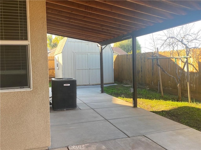 view of patio / terrace with central AC and a shed