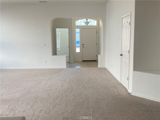 view of carpeted entrance foyer