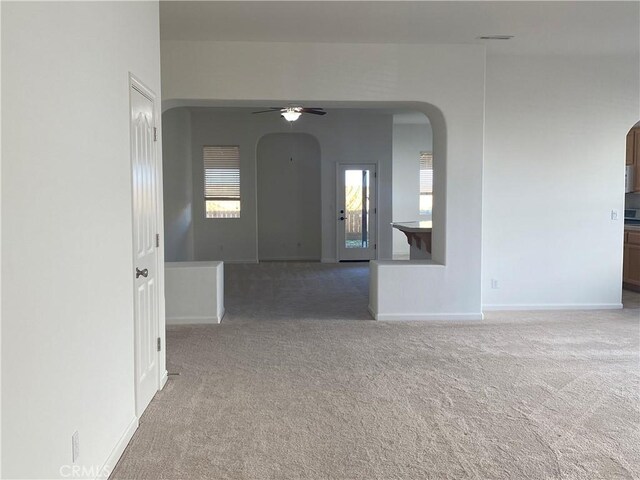 carpeted spare room with ceiling fan