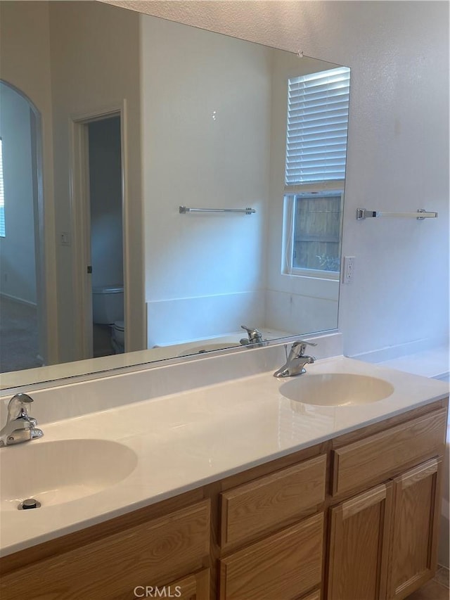 bathroom featuring toilet and vanity