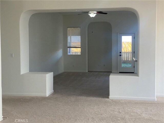 unfurnished room with carpet and ceiling fan