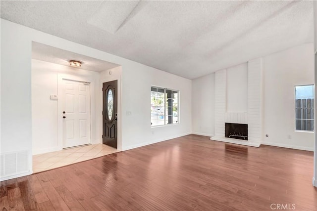 unfurnished living room with light hardwood / wood-style flooring and a fireplace