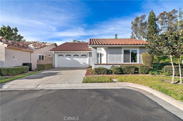 mediterranean / spanish-style house with a garage