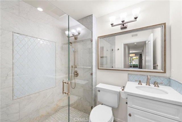 bathroom with vanity, toilet, and an enclosed shower